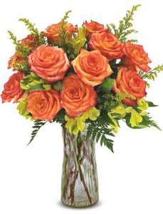 12 orange roses in clear vase
